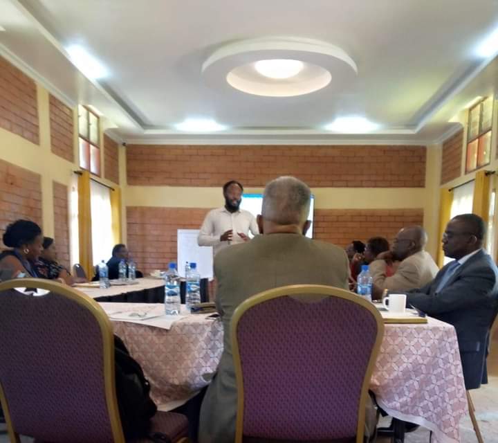 A team from client and contractors are being briefed on a regular security risk situation before embarking on the day's field activities.