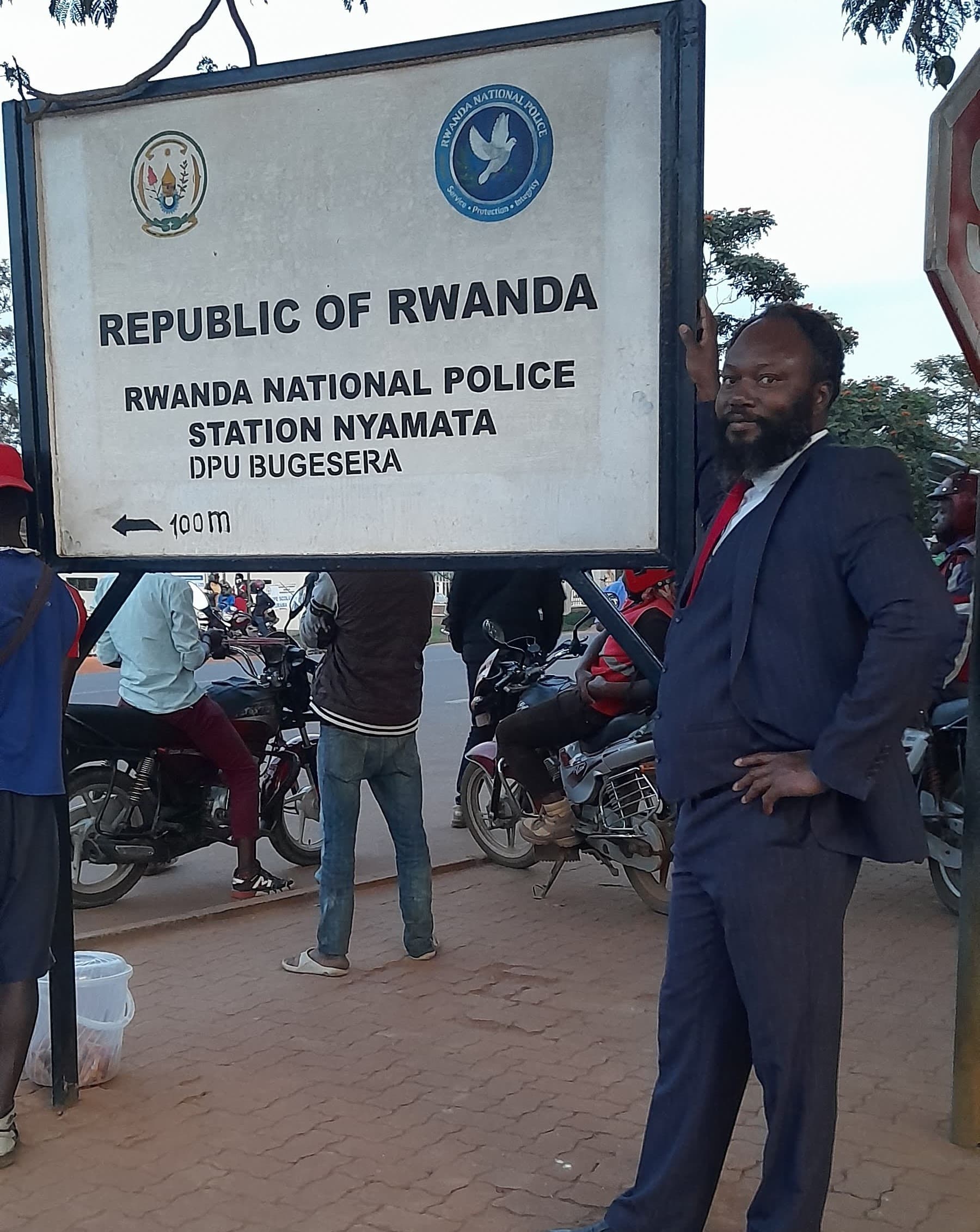 Envag Managing Director Dr Charles Omondi taking a Photo at the signboard to Rwanda Police Station in Bugesera to symbolize the role played by police including international collaborations.