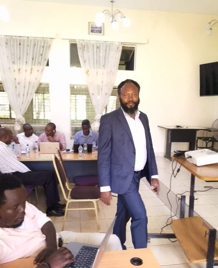 Training Client Organization in Migori County in Kenya - The Managing Director rises up to introduce Envag Consultants at the Start of the Session.